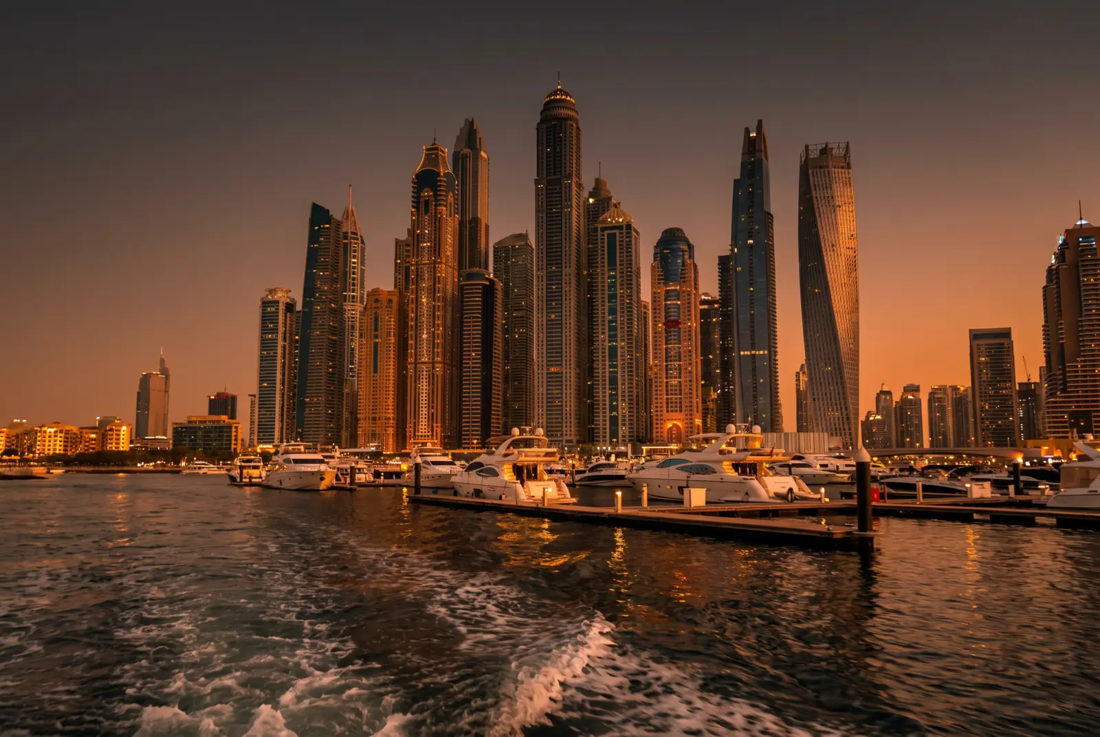 Dubai Marina towers at golden hour seen from the water