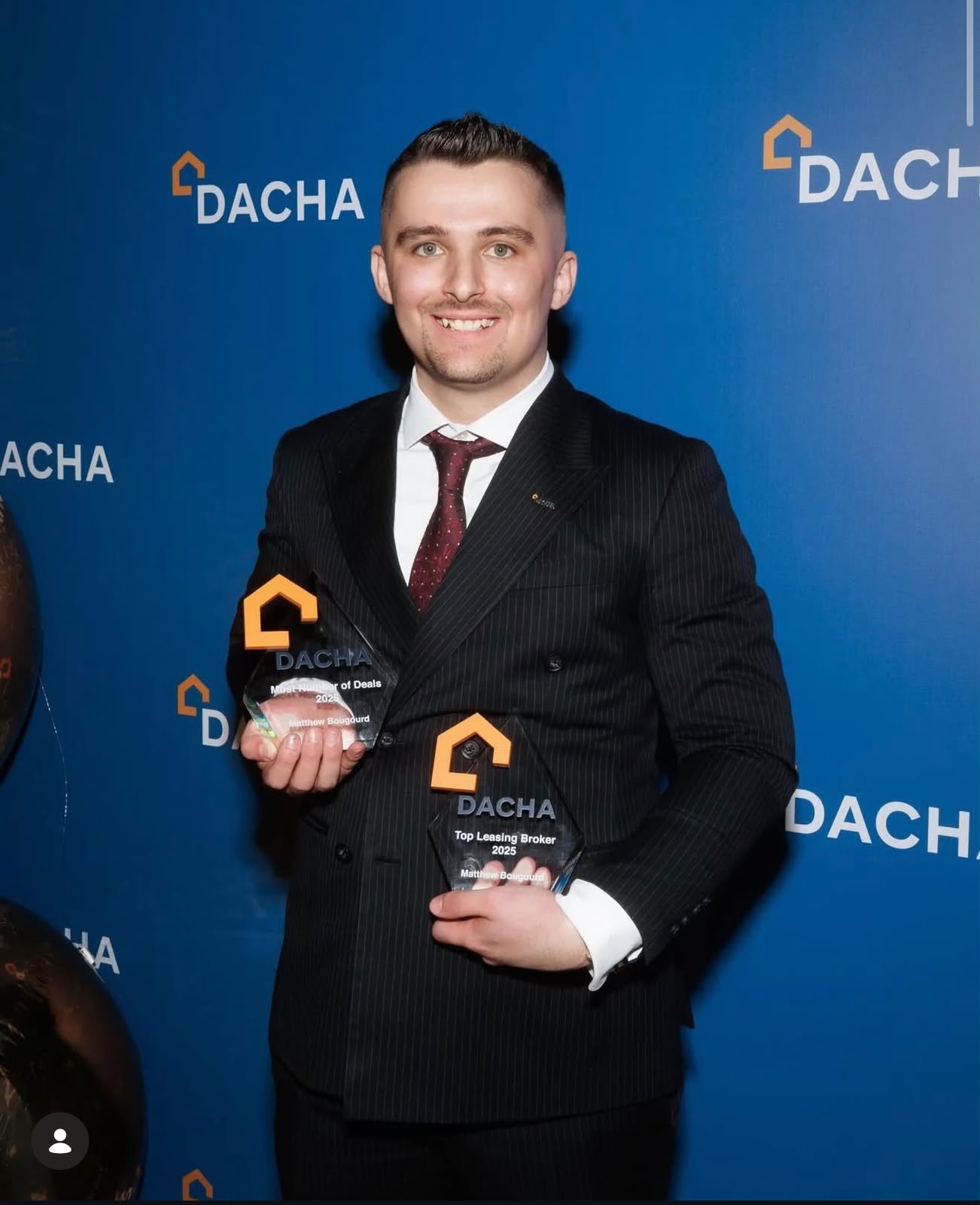 Matt Bougourd holding the Dacha Most Number of Deals 2025 and Top Leasing Broker 2025 trophies at the annual awards