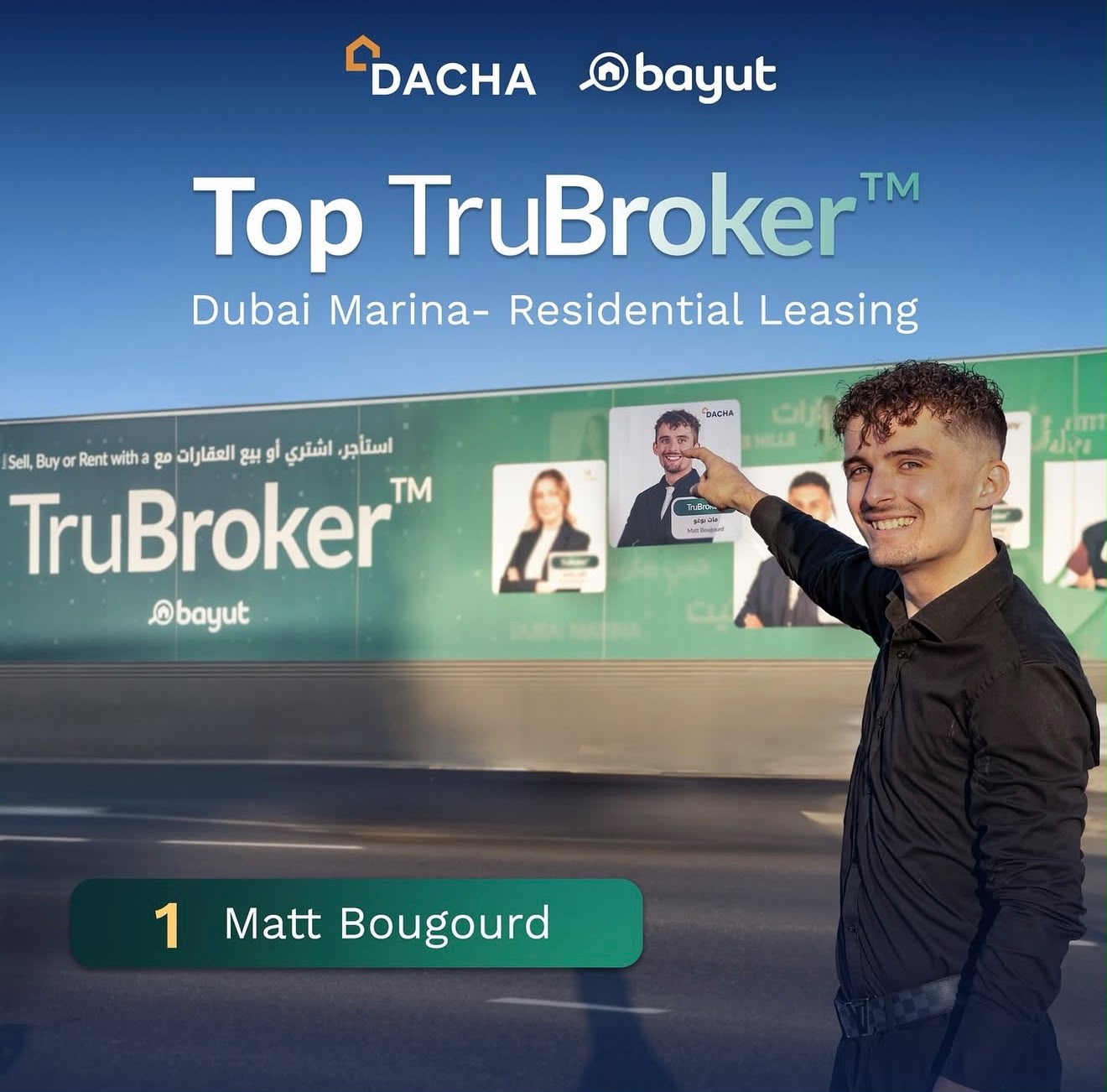 Matt Bougourd pointing at his own portrait on a Bayut TruBroker billboard on Sheikh Zayed Road